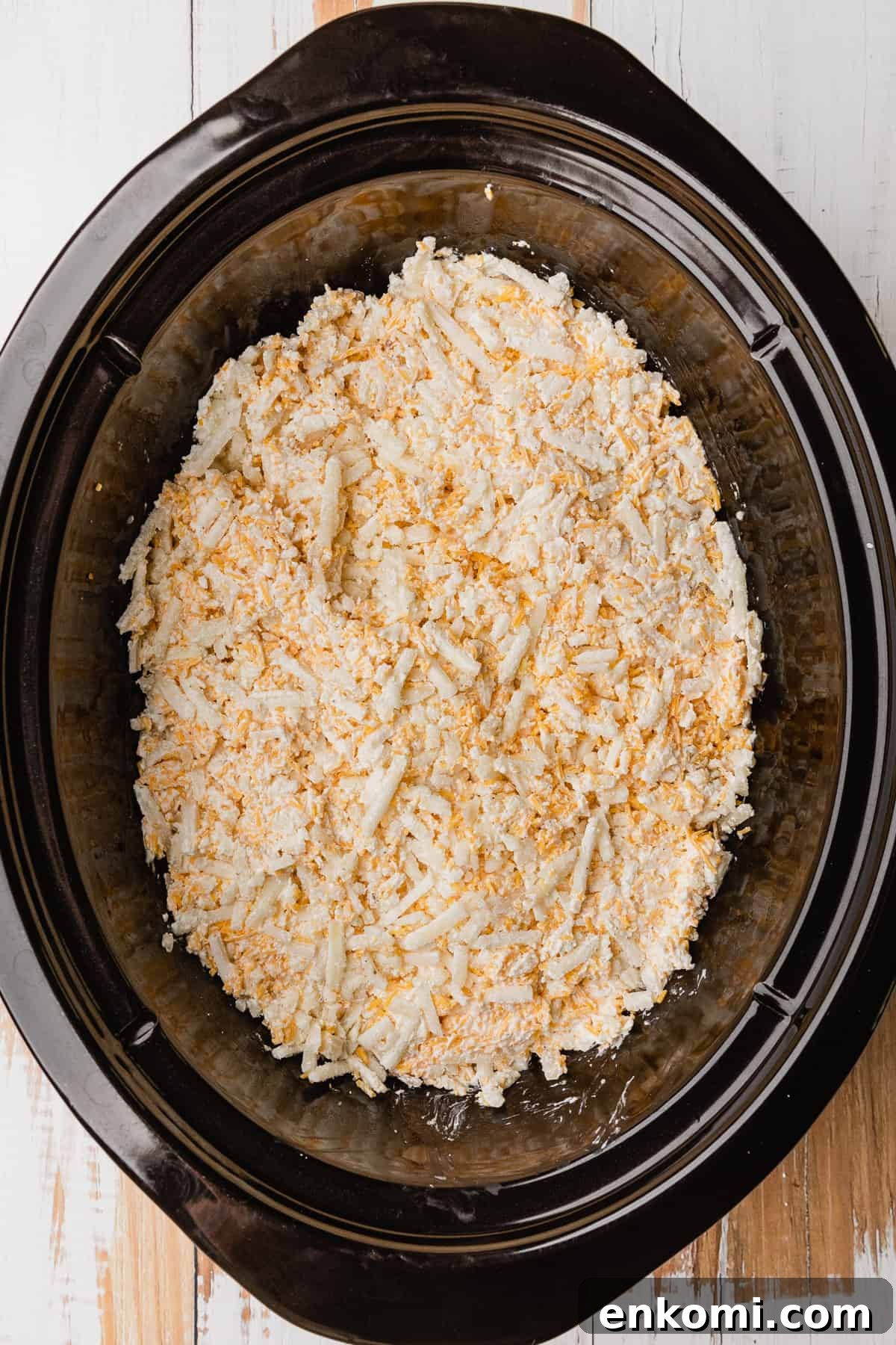 Crockpot Cheesy Hashbrown Casserole Recipe for Slow Cooker 5 Adding mixture to crockpot.