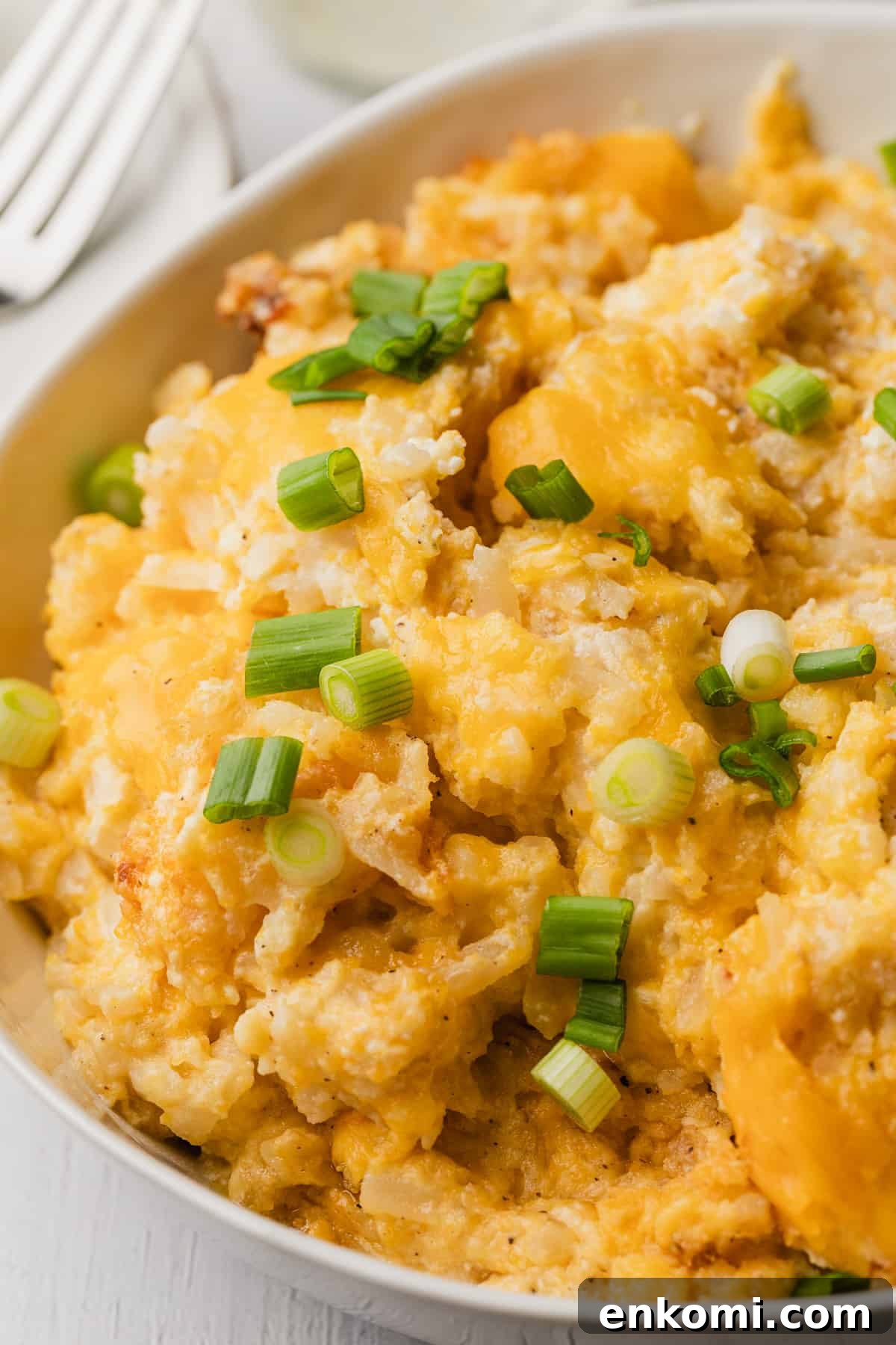 Crockpot Cheesy Hashbrown Casserole Recipe for Slow Cooker 8 The completed recipe in a dish being served.