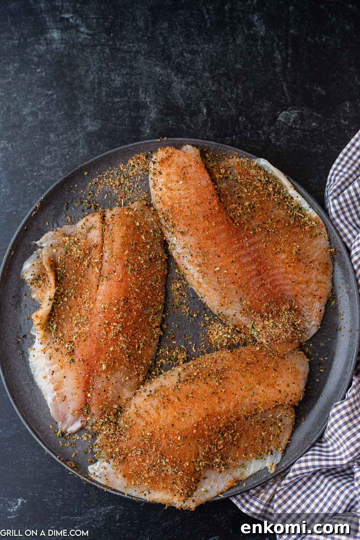 Adding the blackened seasoning to the Tilapia