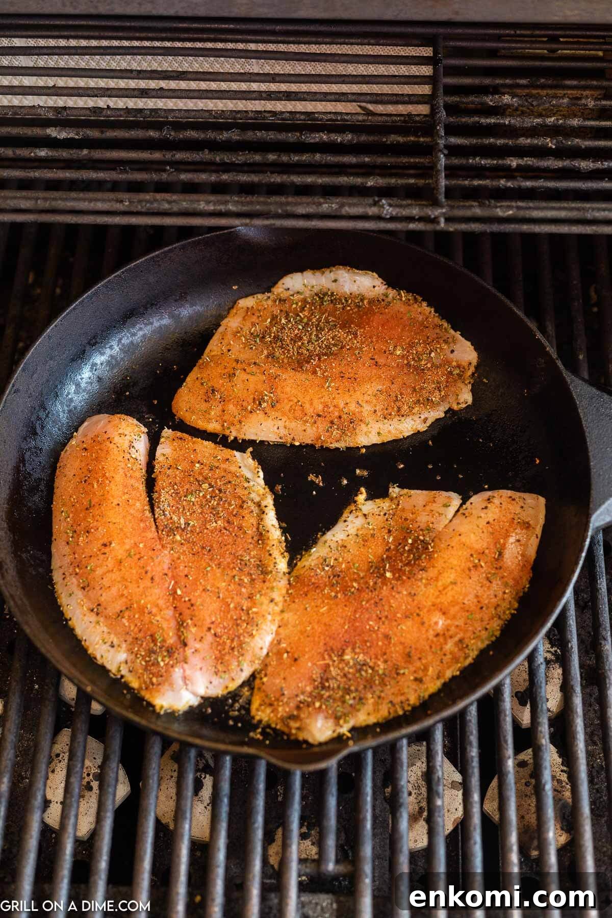 Placing blackened tilapia in a cast iron skillet
