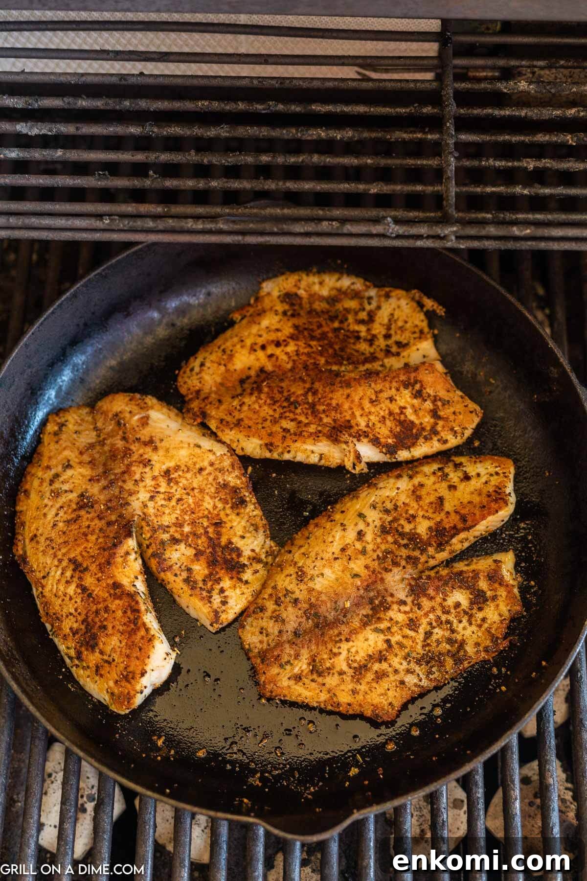 Blackened Tilapia in a cast iron skillet on the grill