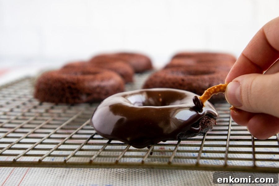 Spider Donuts: How to Make Spooky Halloween Donuts at Home 5 pressing a pretzel leg into a donut