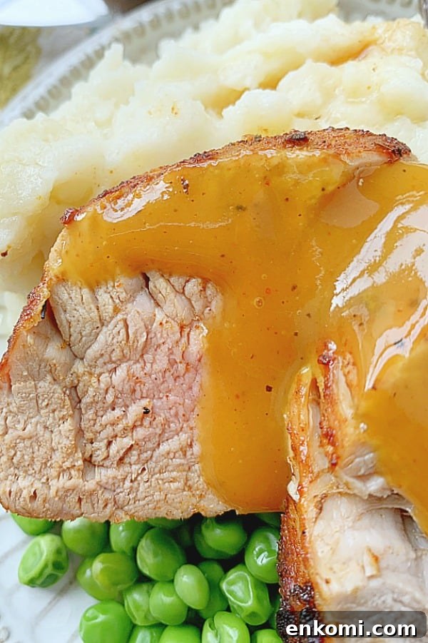 close up of pork tenderloin slices on a plate with bbq sauce