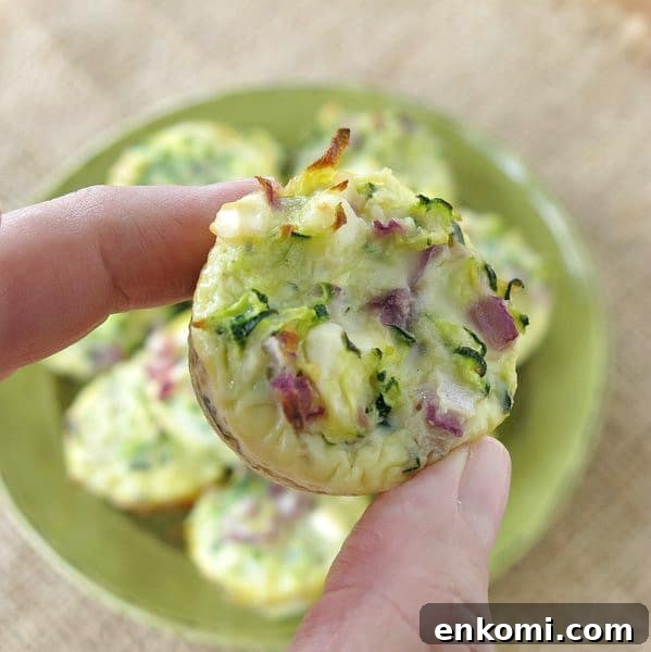 Fingers holding Zucchini Egg Mini Muffins 