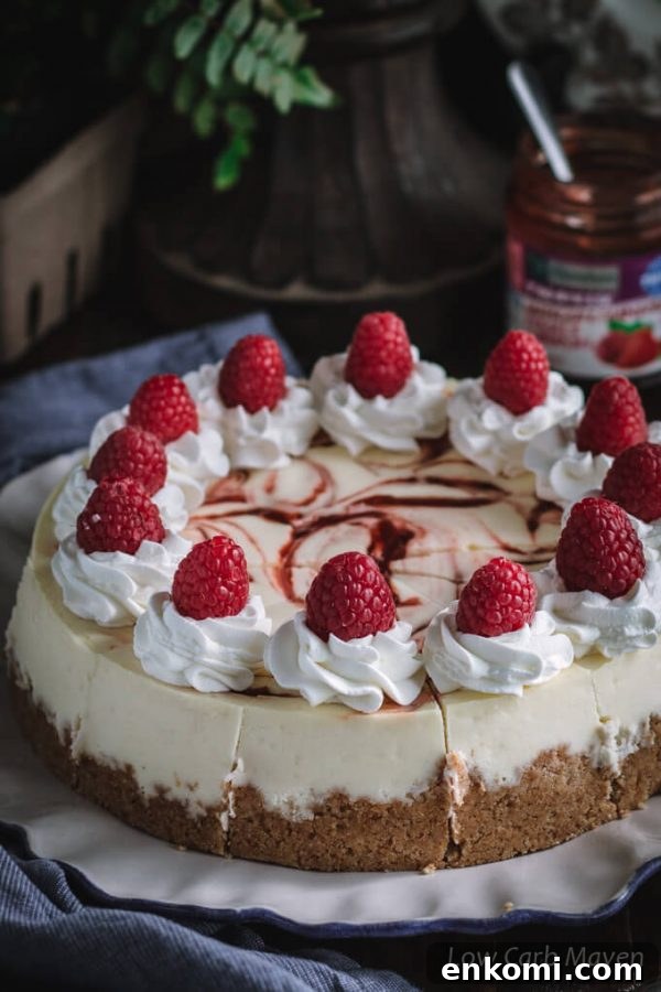 This keto cheesecake with raspberry swirl is delicious and perfect for a low carb and sugar free diet. No-added sugar strawberry/raspberry jam by Sukrin makes the perfect swirl.