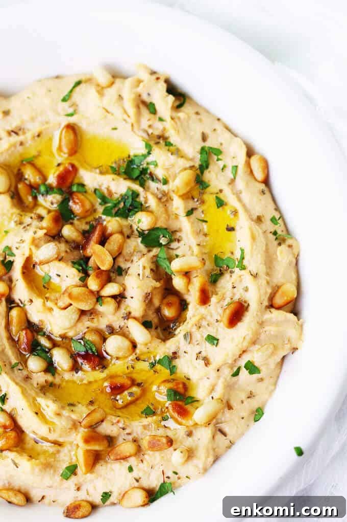 Chipotle Hummus with Roasted Pine Nuts is very simple and super delicious with a hint of smokiness from spicy chipotles and nice crunch from roasted pine nuts.