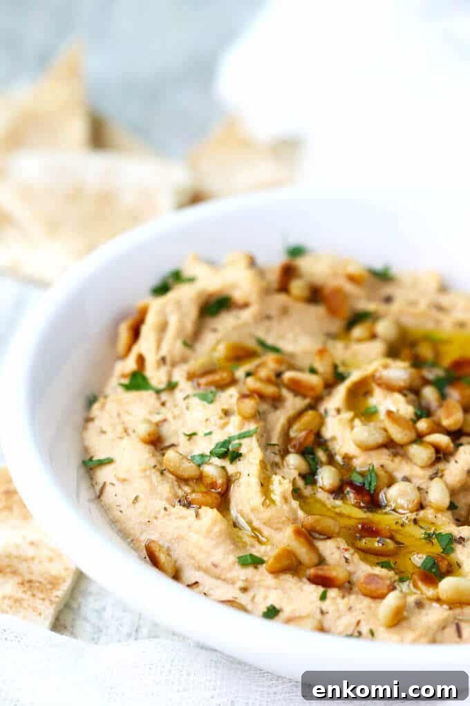 Smoky Chipotle Hummus with Roasted Pine Nuts 3 Chipotle Hummus with Roasted Pine Nuts is very simple and delicious with a hint of smokiness from spicy chipotles and nice crunch from roasted pine nuts.