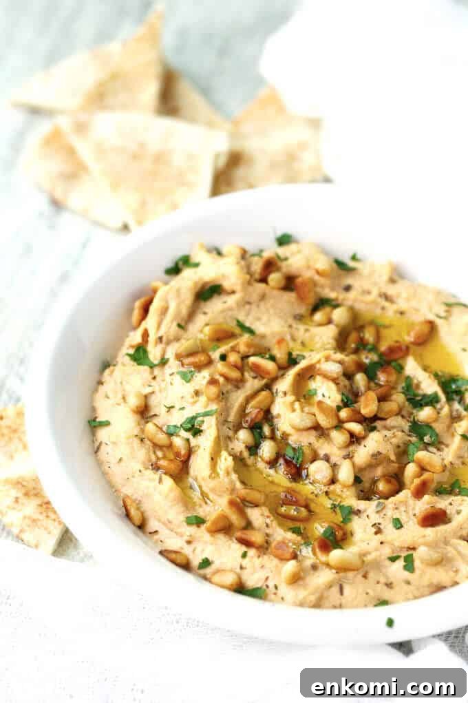 Smoky Chipotle Hummus with Roasted Pine Nuts 4 Chipotle Hummus with Roasted Pine Nuts is very simple and delicious with a hint of smokiness from spicy chipotles and nice crunch from roasted pine nuts.