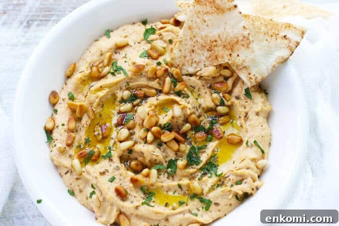Smoky Chipotle Hummus with Roasted Pine Nuts 6 Chipotle Hummus with Roasted Pine Nuts is very simple and delicious with a hint of smokiness from spicy chipotles and nice crunch from roasted pine nuts.