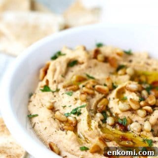 Smoky Chipotle Hummus with Roasted Pine Nuts 7 Chipotle Hummus with Roasted Pine Nuts is very simple and super delicious with a hint of smokiness from spicy chipotles and nice crunch from roasted pine nuts.