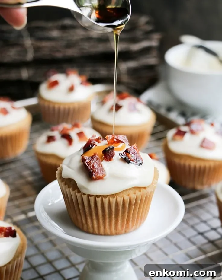 Syrup being poured on to a Glazed Bacon Maple Muffin by themerchantbaker.com