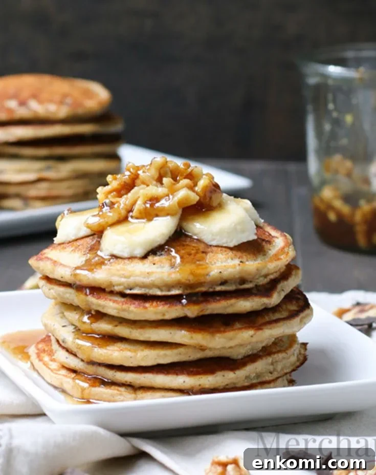 A stack of Oatmeal Chocolate Chip Banana Pancakes by themerchantbaker.com