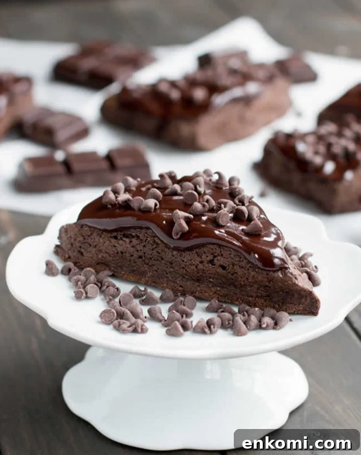 Dark Chocolate Fudge Scone with mini chocolate chips on a pedestal by themerchantbaker.com