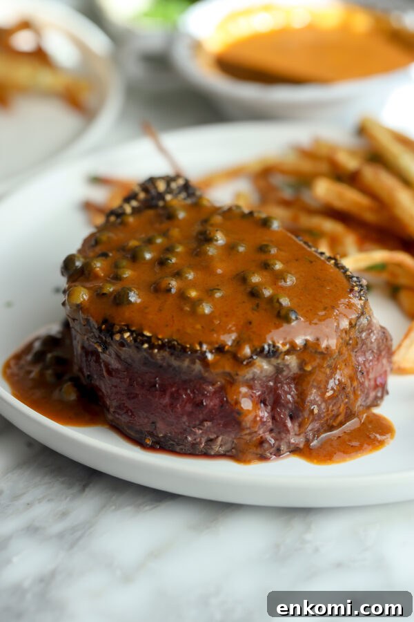 Creamy Lemon Martini with Olive Brine Twist 6 A gorgeous tenderloin steak covered in a peppercorn sauce with crispy fries in the background.