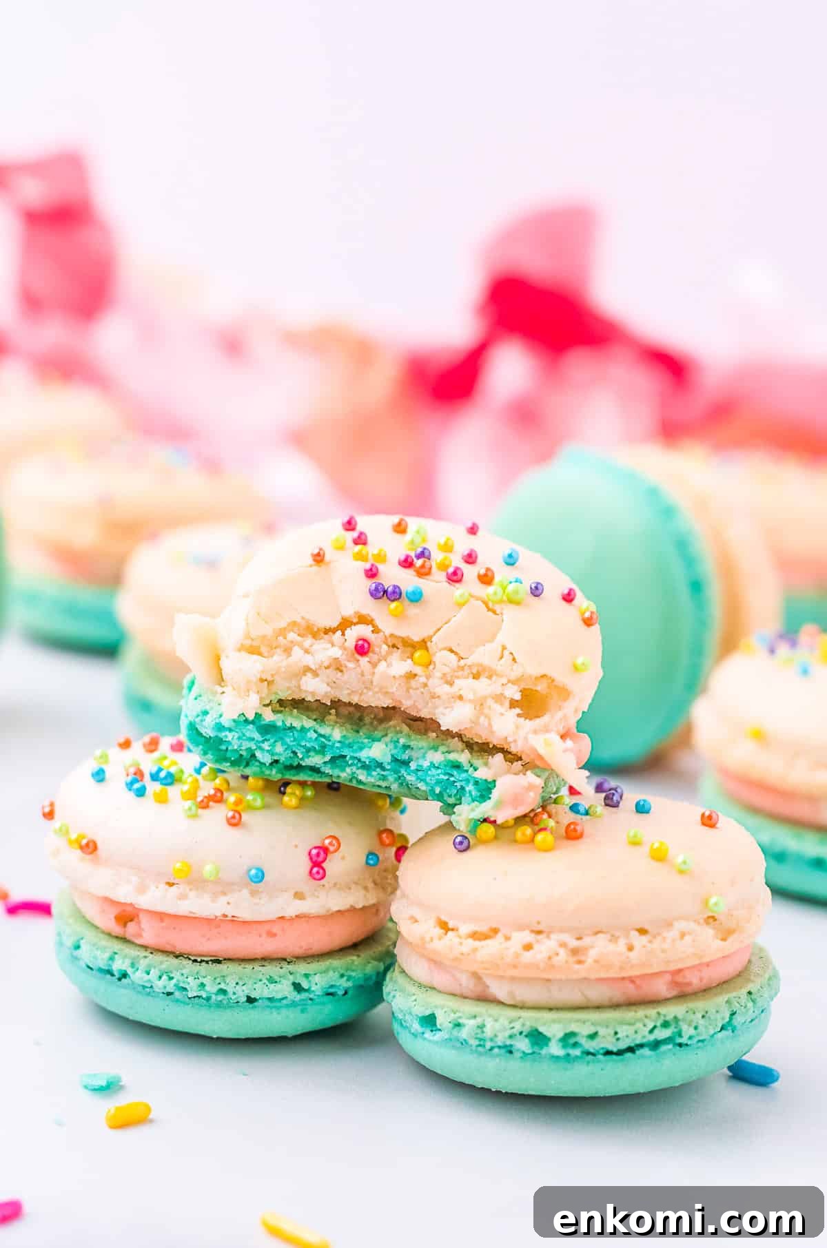 birthday cake macarons with a bite taken out of it