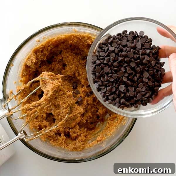 Gluten-Free Levain-Style Chocolate Chip Cookies Recipe 6 Adding chocolate chips to cookie dough