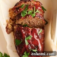 A southern meatloaf on a sheet of parchment paper in a baking dish.