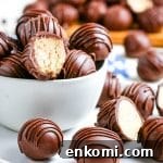 Classic Old-Fashioned Peanut Butter Balls Recipe 11 Peanut butter balls stacked in a white glass bowl