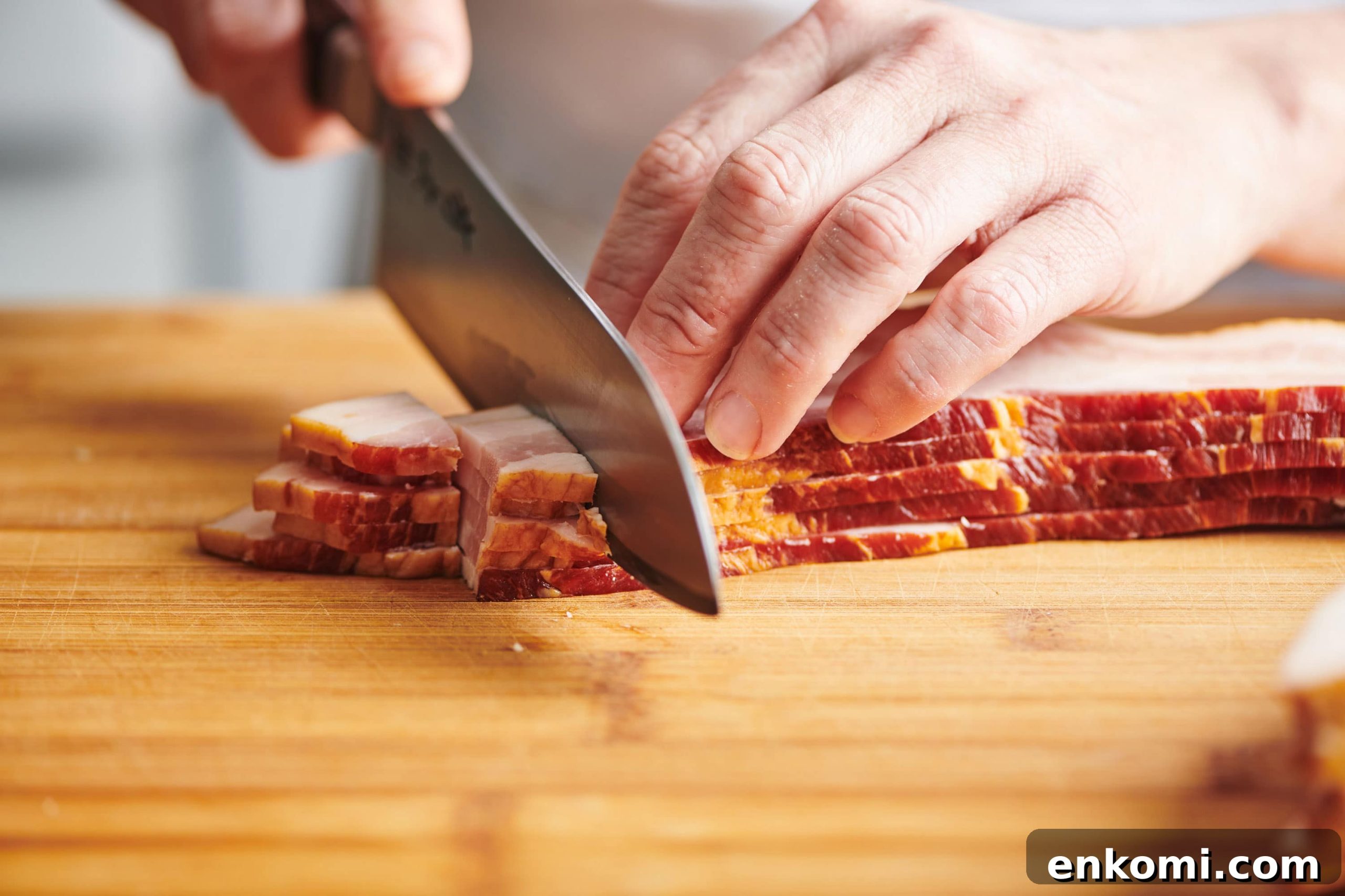 Crispy Bacon Lardons Recipe: Step-by-Step Guide 3 Chopping bacon into lardons with chef knife.