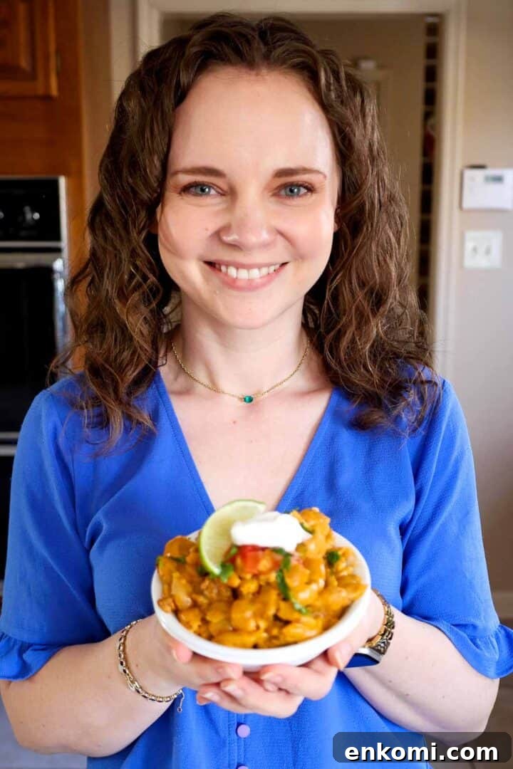 Kelsey Smith holding a bowl of taco mac and cheese.