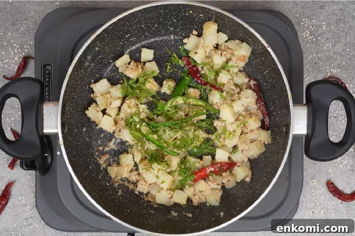 Sesame Potato Stir-Fry (Til Wale Aloo) Recipe 10 Lime juice, green chilies and cilantro added to the pan.