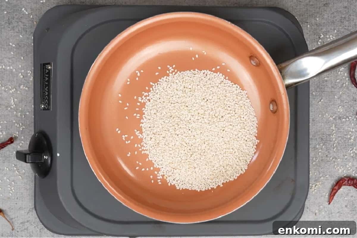 Sesame Potato Stir-Fry (Til Wale Aloo) Recipe 4 Sesame seeds added to the skillet.