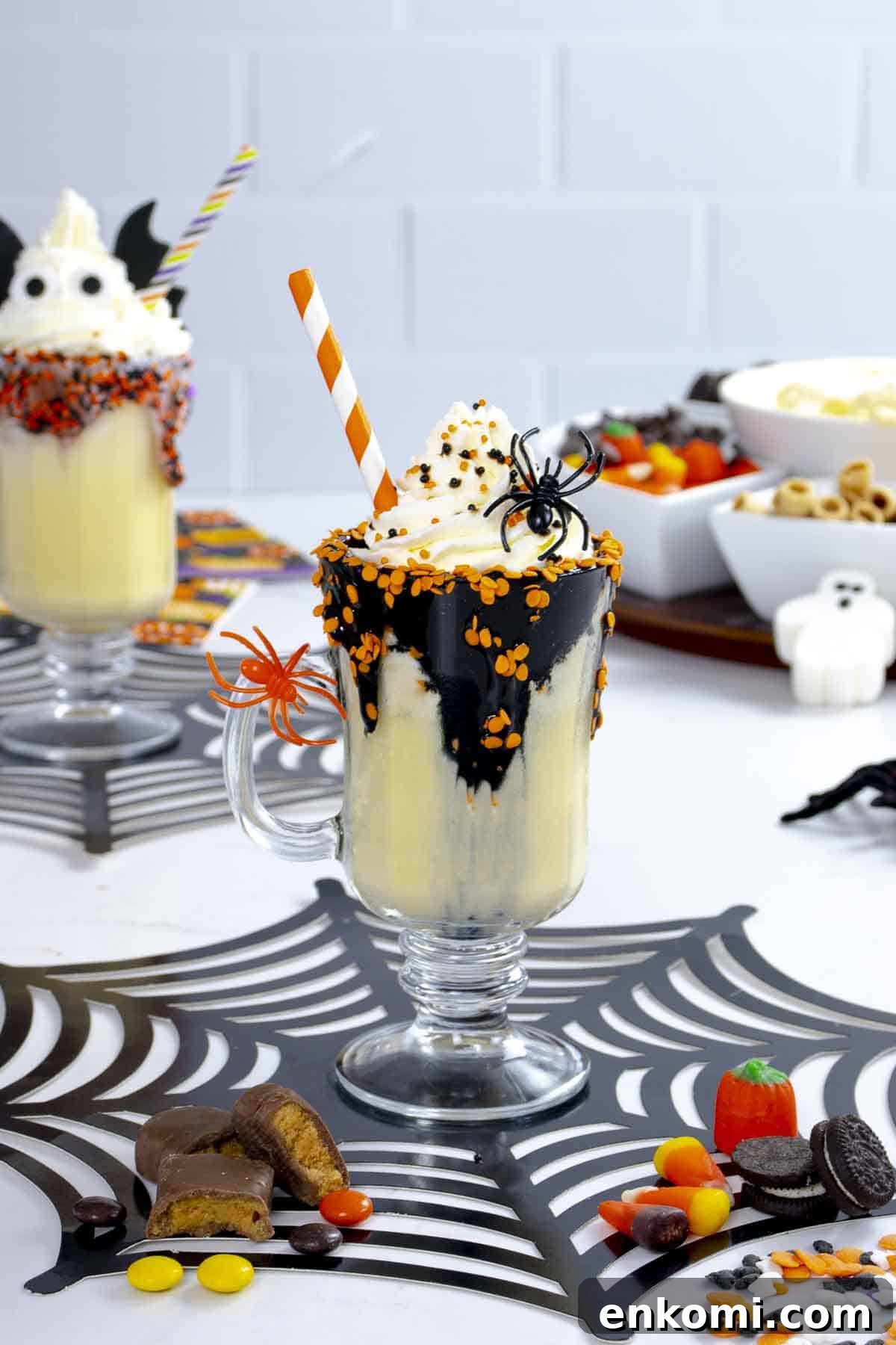 Halloween Milkshake Bar Ideas for Kids: Spooky Flavors & Toppings 4 Vanilla milkshake with chocolate sauce and whipped cream and spider decor.