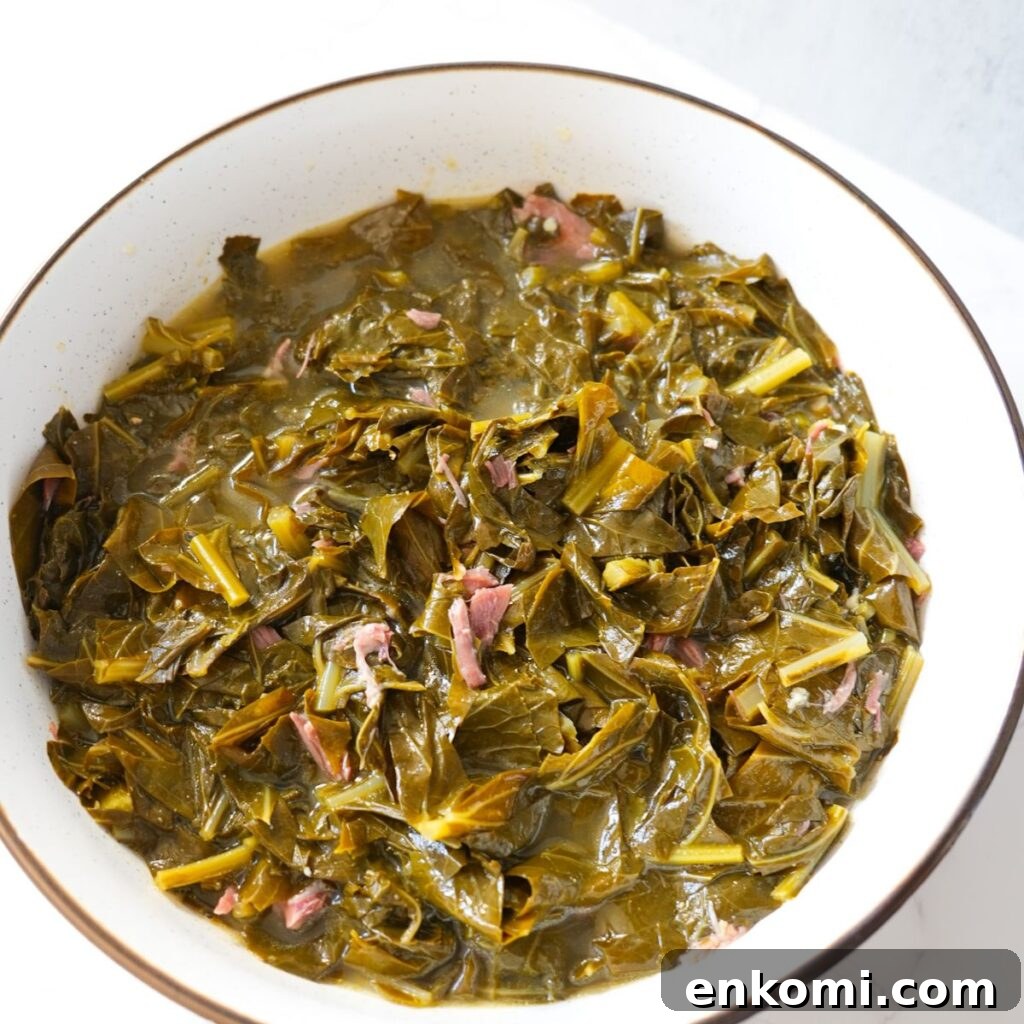 Tender soul food collard greens with smoked meat and savory broth.