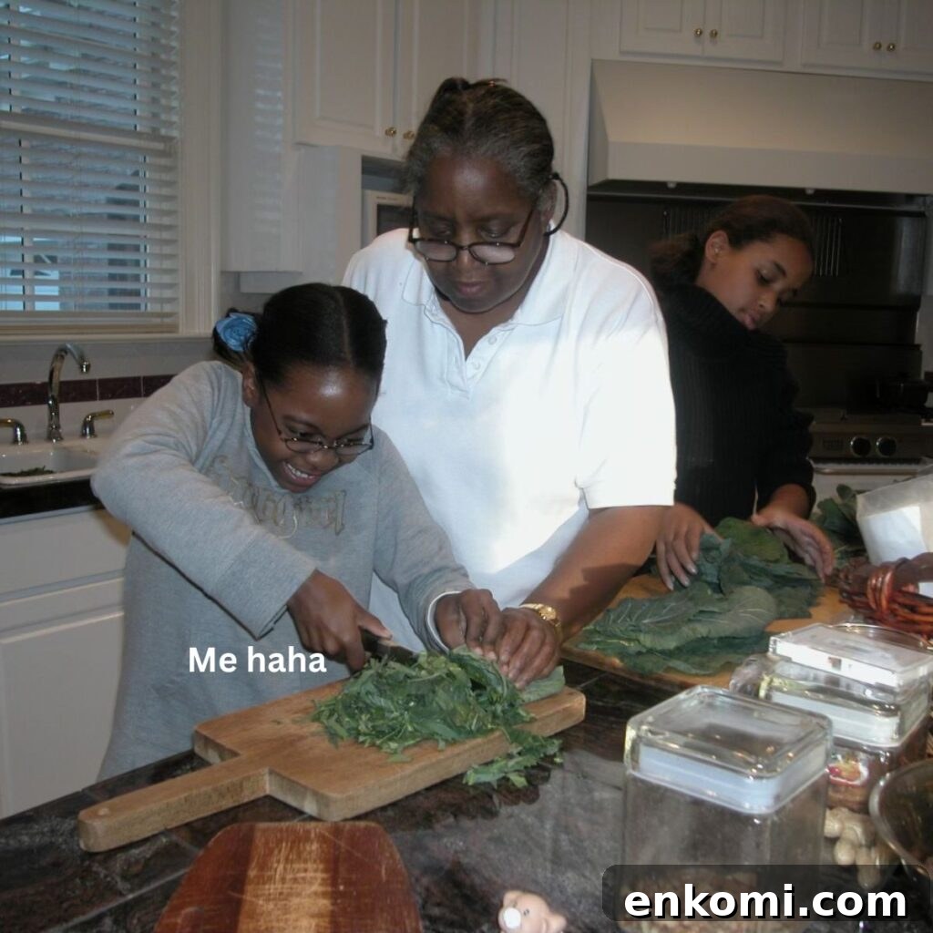 Photo of a younger August, cutting collard greens. 