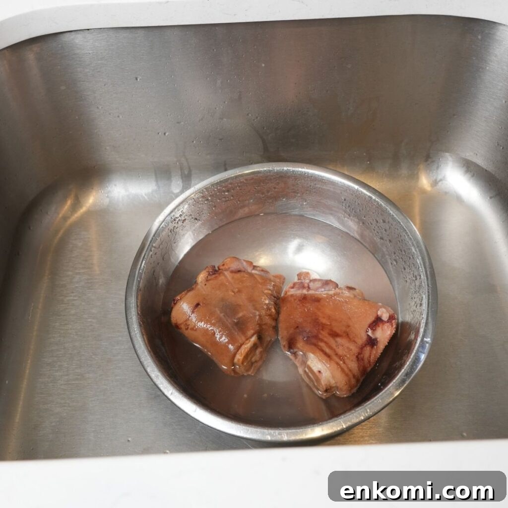 Ham hocks in a bowl with water and vinegar. 
