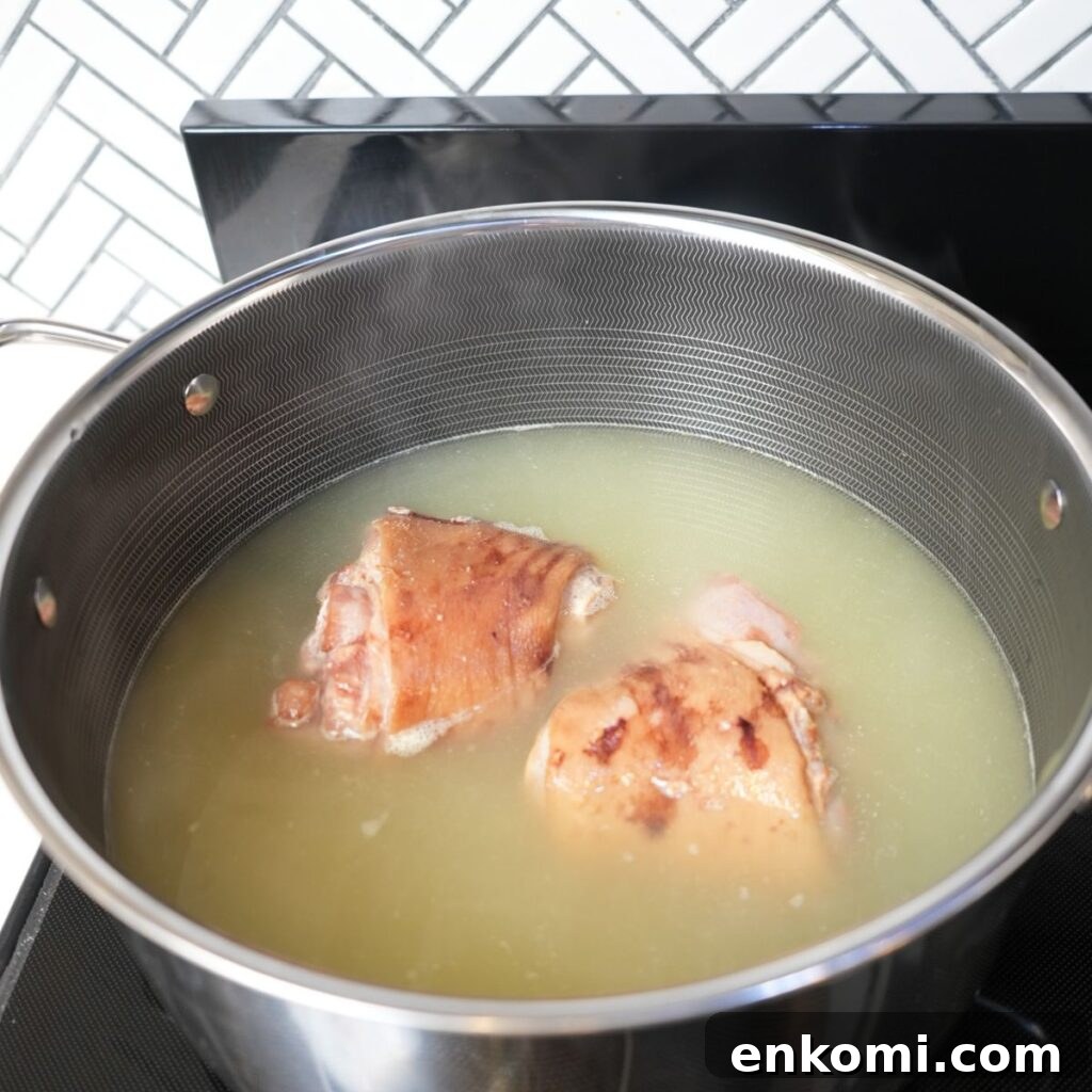 Ham hocks simmering in chicken broth. 