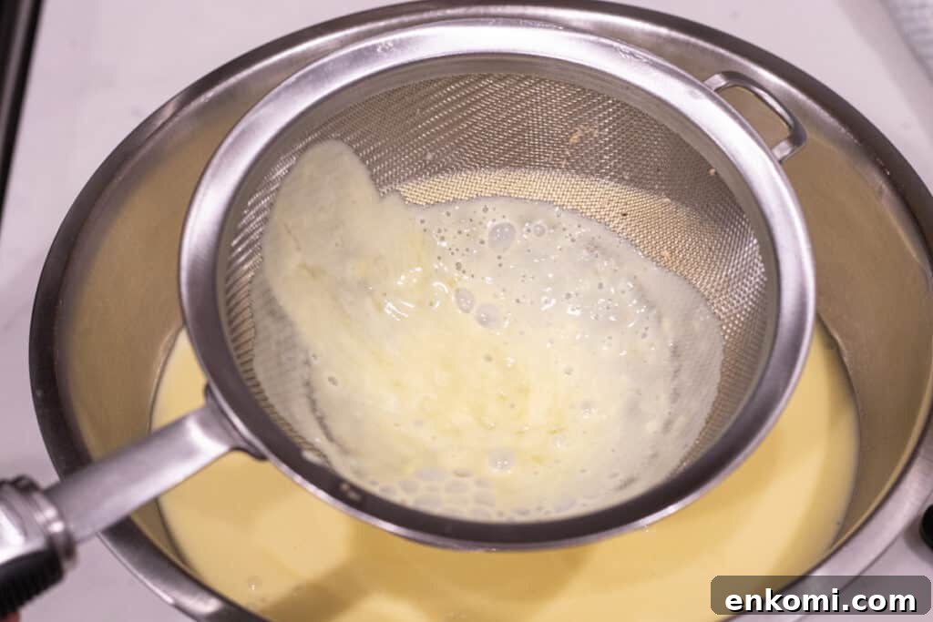 Salted Caramel Chocolate Budino Recipe for Decadent Dessert 5 custard poured through fine mesh sieve