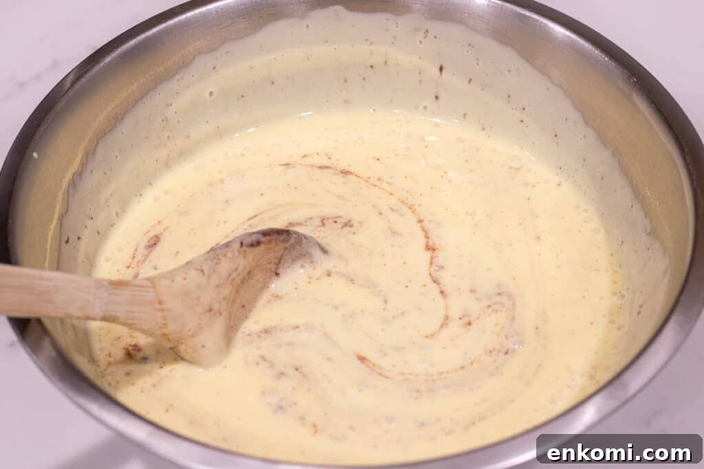 Salted Caramel Chocolate Budino Recipe for Decadent Dessert 6 stirring custard and chocolate together in bowl
