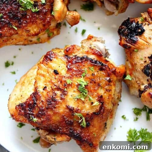 Square image of chicken thighs cooked in the Instant Pot, arranged on a white plate.