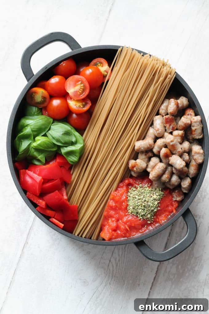 Creamy One-Pot Sausage and Tomato Spaghetti Recipe 3 ingredients for one pot creamy pasta arranged in a large black saucepan