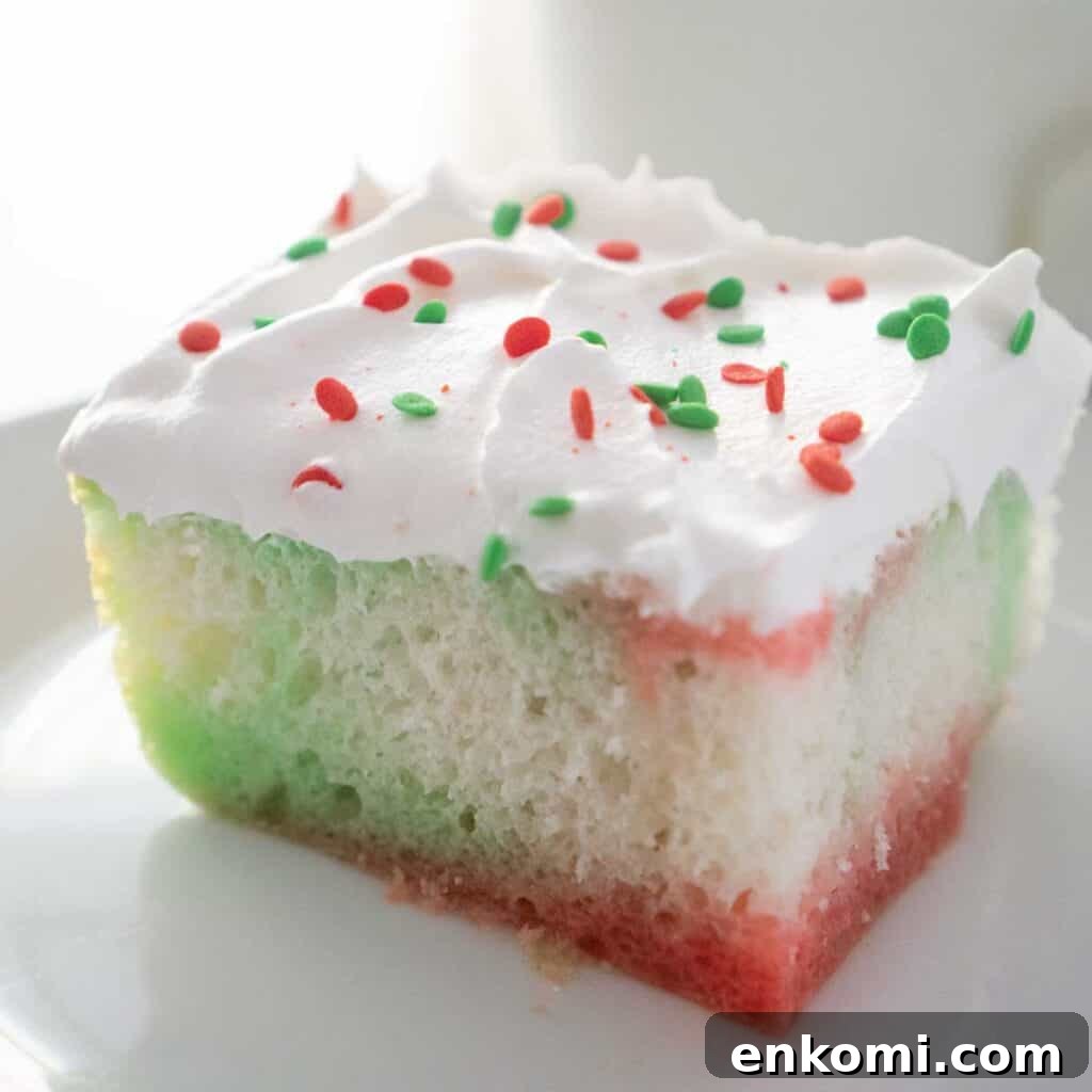 15 Irresistible Poke Cake Recipes to Try Tonight 14 piece of christmas jello poke cake on white plate