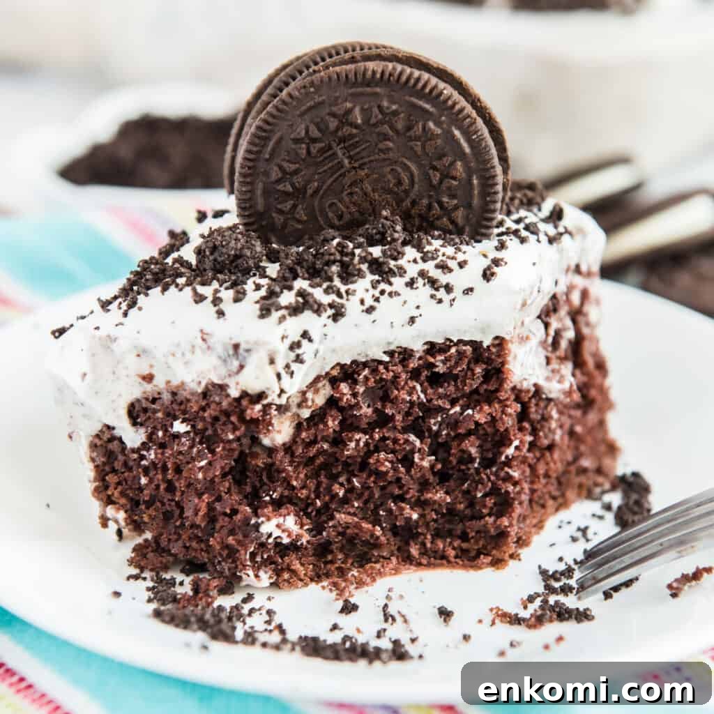 15 Irresistible Poke Cake Recipes to Try Tonight 3 oreo poke cake with oreo cookie on top on white plate