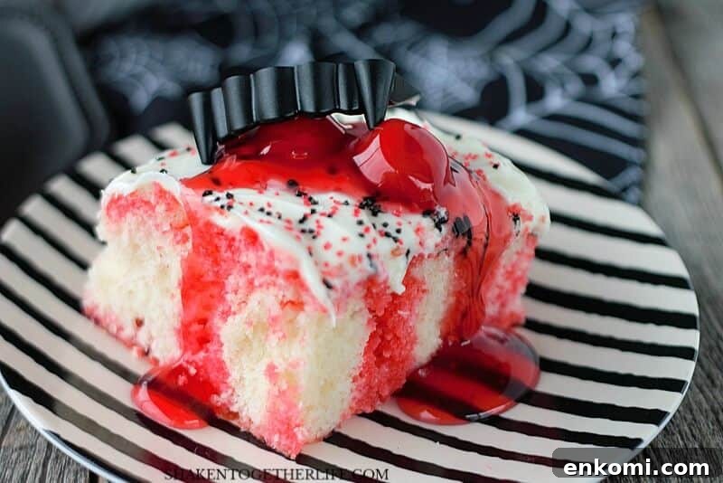 15 Irresistible Poke Cake Recipes to Try Tonight 5 Cherry Vanilla Vampire Poke Cake on black and white striped plate