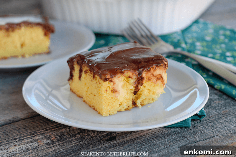 15 Irresistible Poke Cake Recipes to Try Tonight 10 Boston Cream Pie Poke Cake piece on white plate