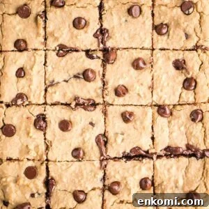 Rows of square cut blondies with chocolate chips.