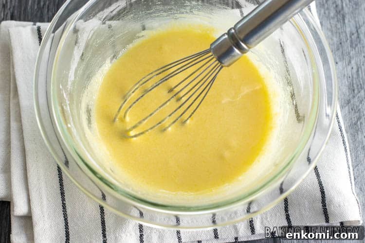 whisk in yellow liquid