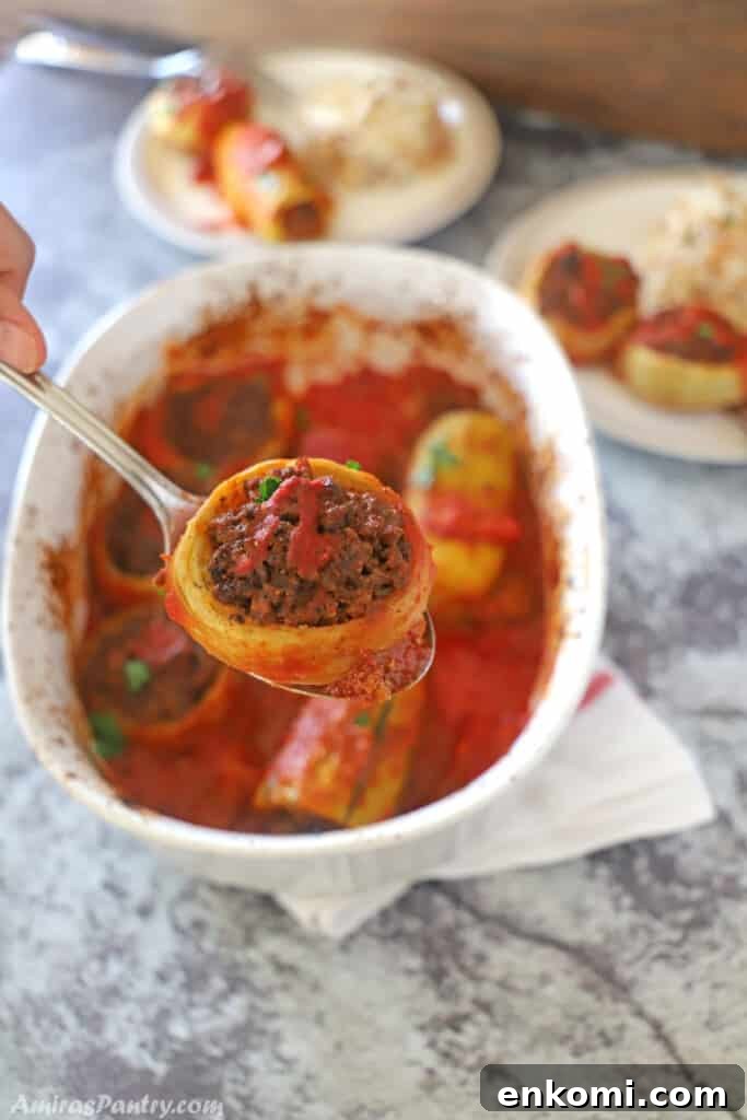 2-Week Family Meal Plan: Simple Recipes & Grocery List 6 A hand holding a spoon with an artichoke stuffed with ground meat.