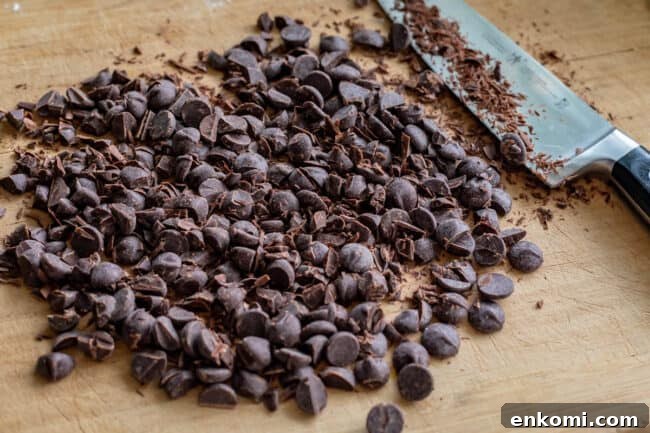 chopped dark chocolate on a cutting board with a knife