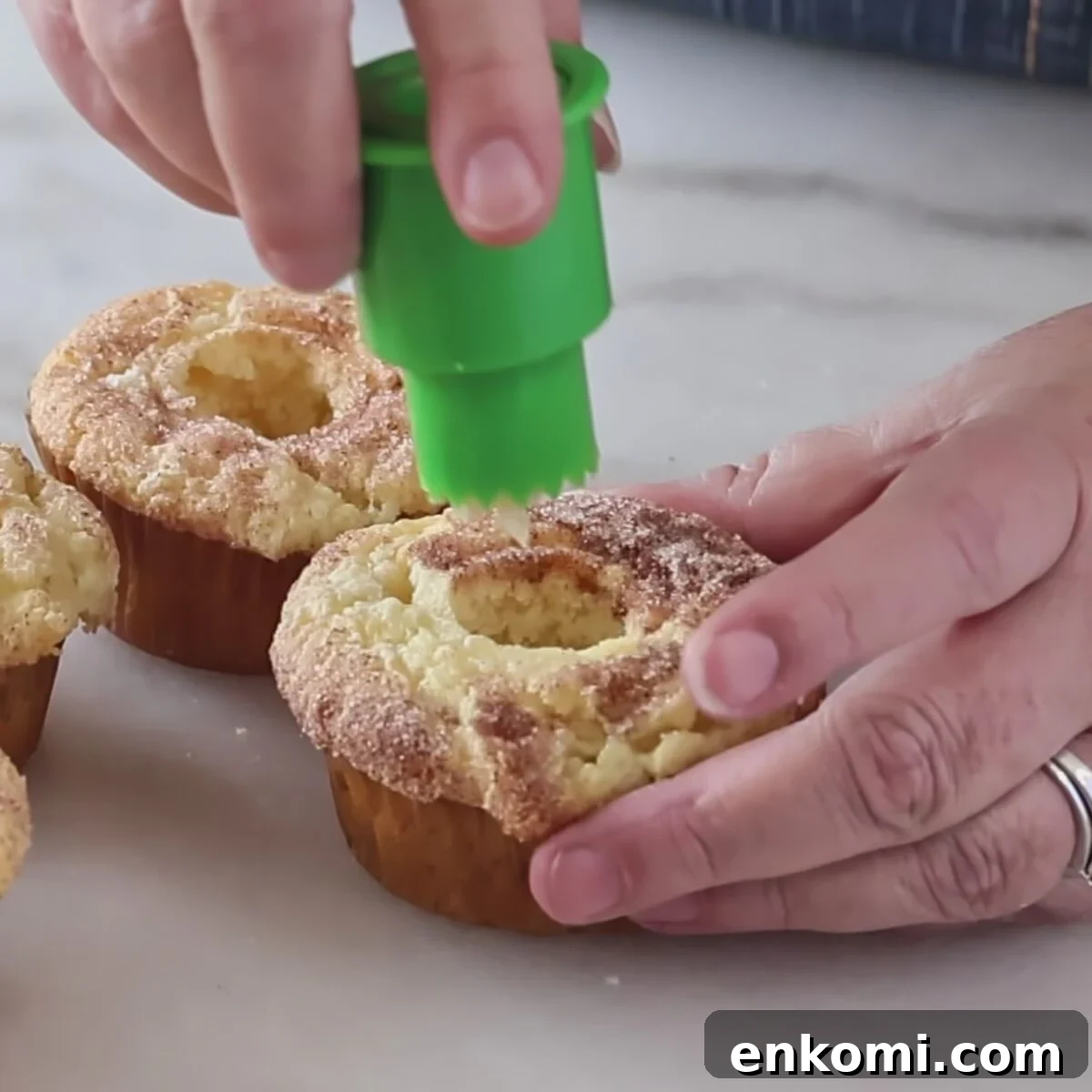 Gluten-Free Churro Cupcakes Recipe with Cinnamon Sugar Topping 17 coring cupcakes using green plastic cupcake corer.