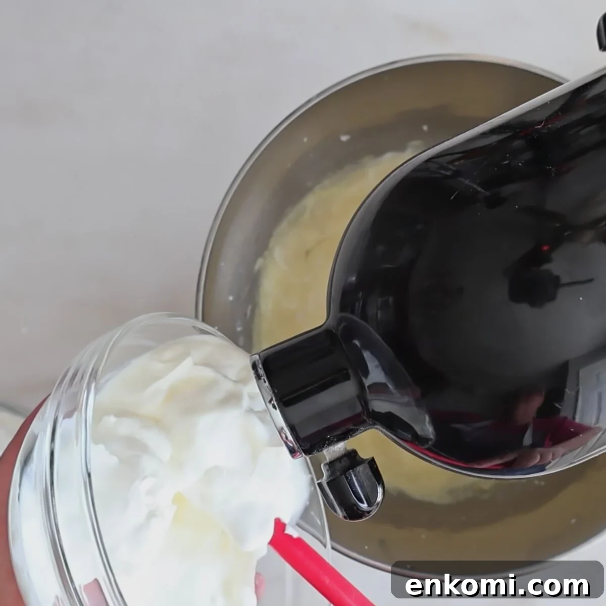 Gluten-Free Churro Cupcakes Recipe with Cinnamon Sugar Topping 9 adding sour cream to batter in black stand mixer.