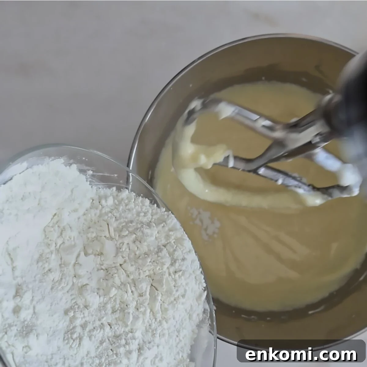 Gluten-Free Churro Cupcakes Recipe with Cinnamon Sugar Topping 10 adding dry ingredients to batter in mixing bowl.