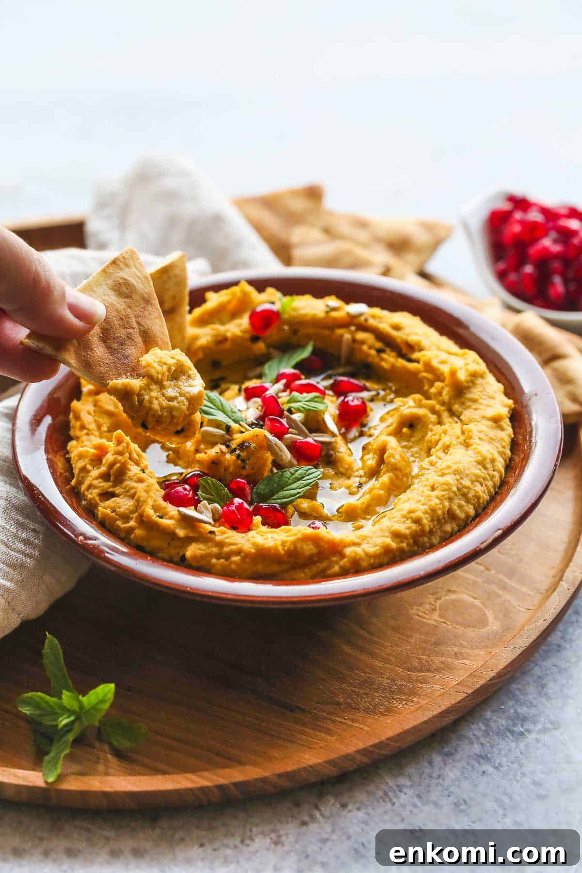 Roasted Sweet Potato Hummus Recipe — Creamy Autumn Dip 7 Eating sweet potato hummus with pita chips