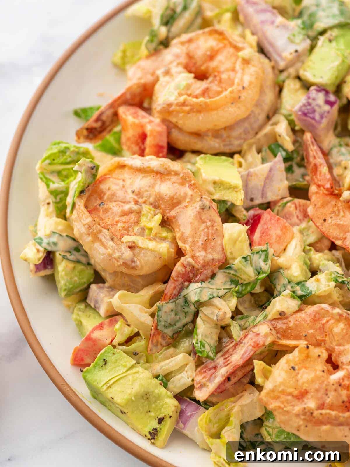 Citrus Shrimp Salad with Crisp Lettuce and Avocado 7 Shrimp avocado salad on a plate.