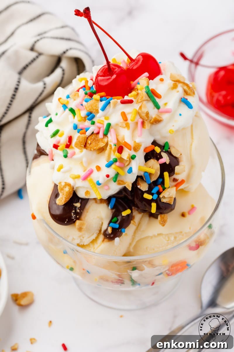 Decadent Hot Fudge Sundae Recipe You’ll Love 5 a sundae topped with hot fudge, whipped cre3am, rainbow sprinkles, peanuts, and two cherries