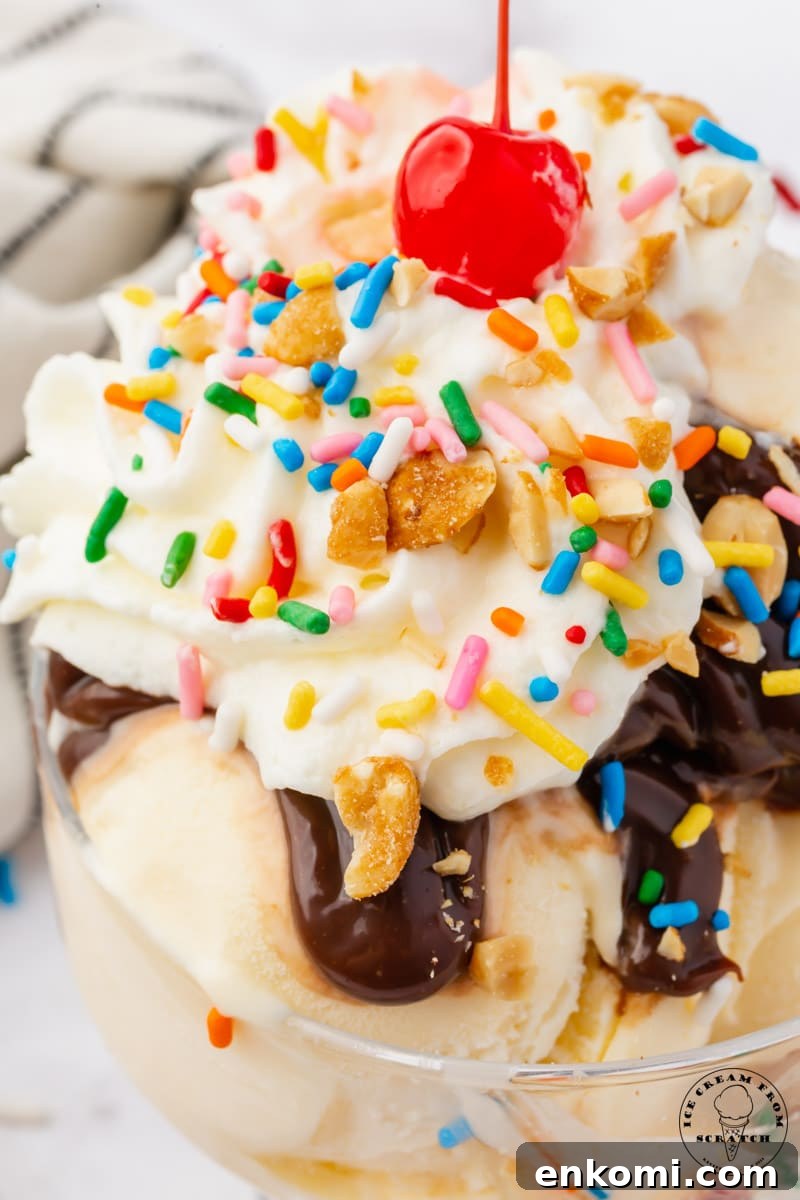 Decadent Hot Fudge Sundae Recipe You’ll Love 7 closeup view of a classic hot fudge sundae with a cherry on top.